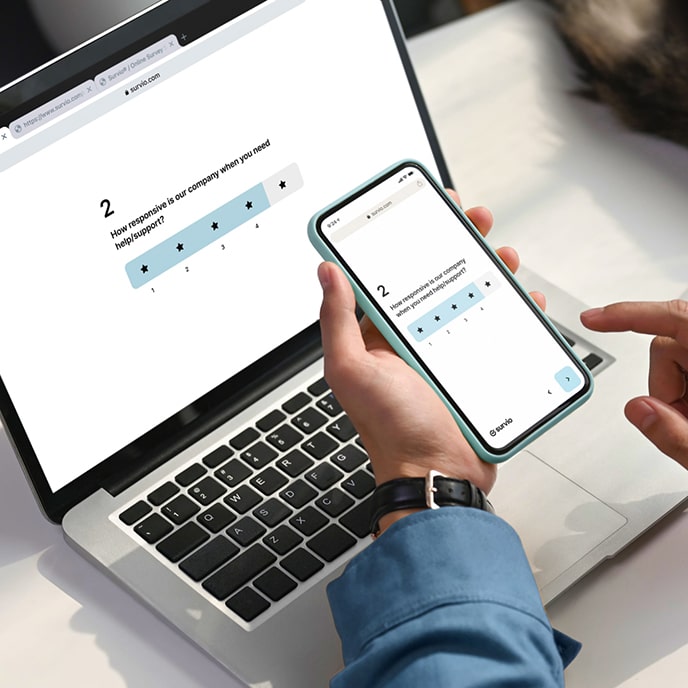 A star rating question displayed on a laptop and cellphone to demonstrate device responsive design of the Survio platform