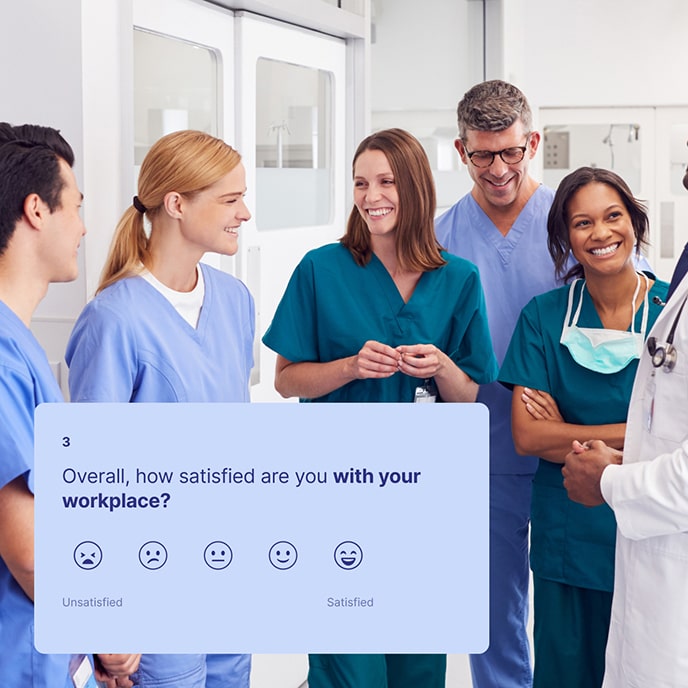 A team of medical staff engaged in a friendly conversation in a hospital corridor.